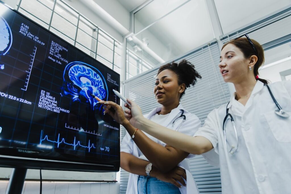 Team of doctors check on scan results | BetaKit Team of doctors check on scan results