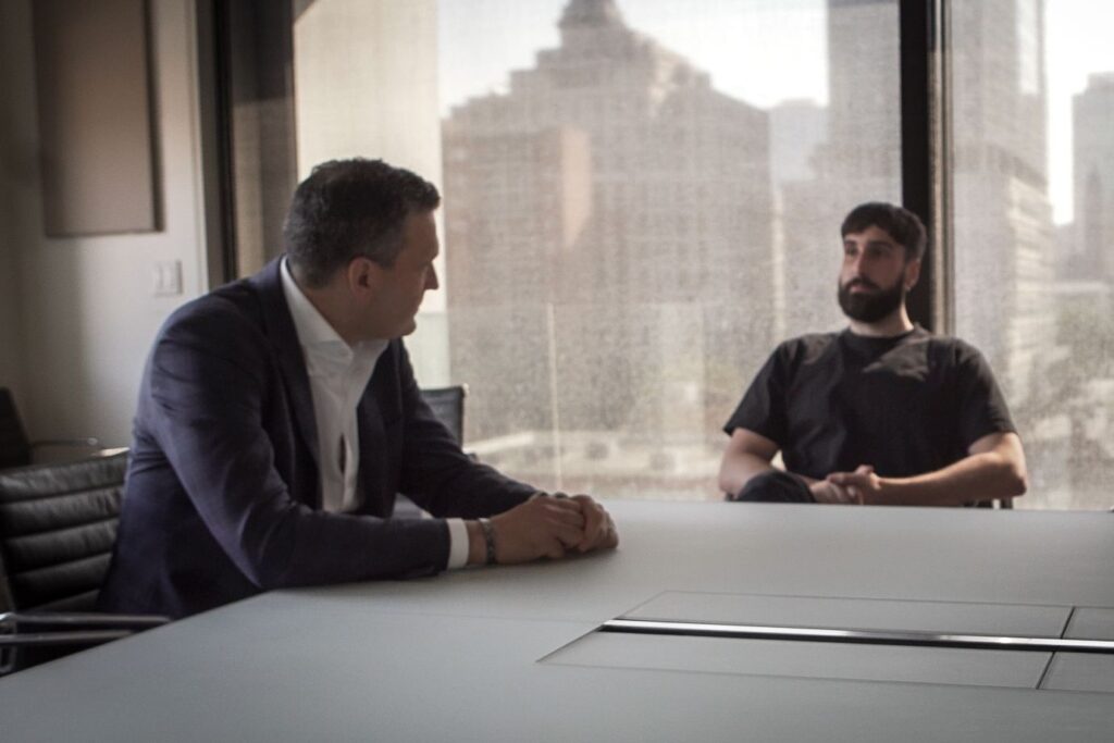 Canadian AI Minister Evan Solomon sitting with Cohere CEO Aidan Gomez.