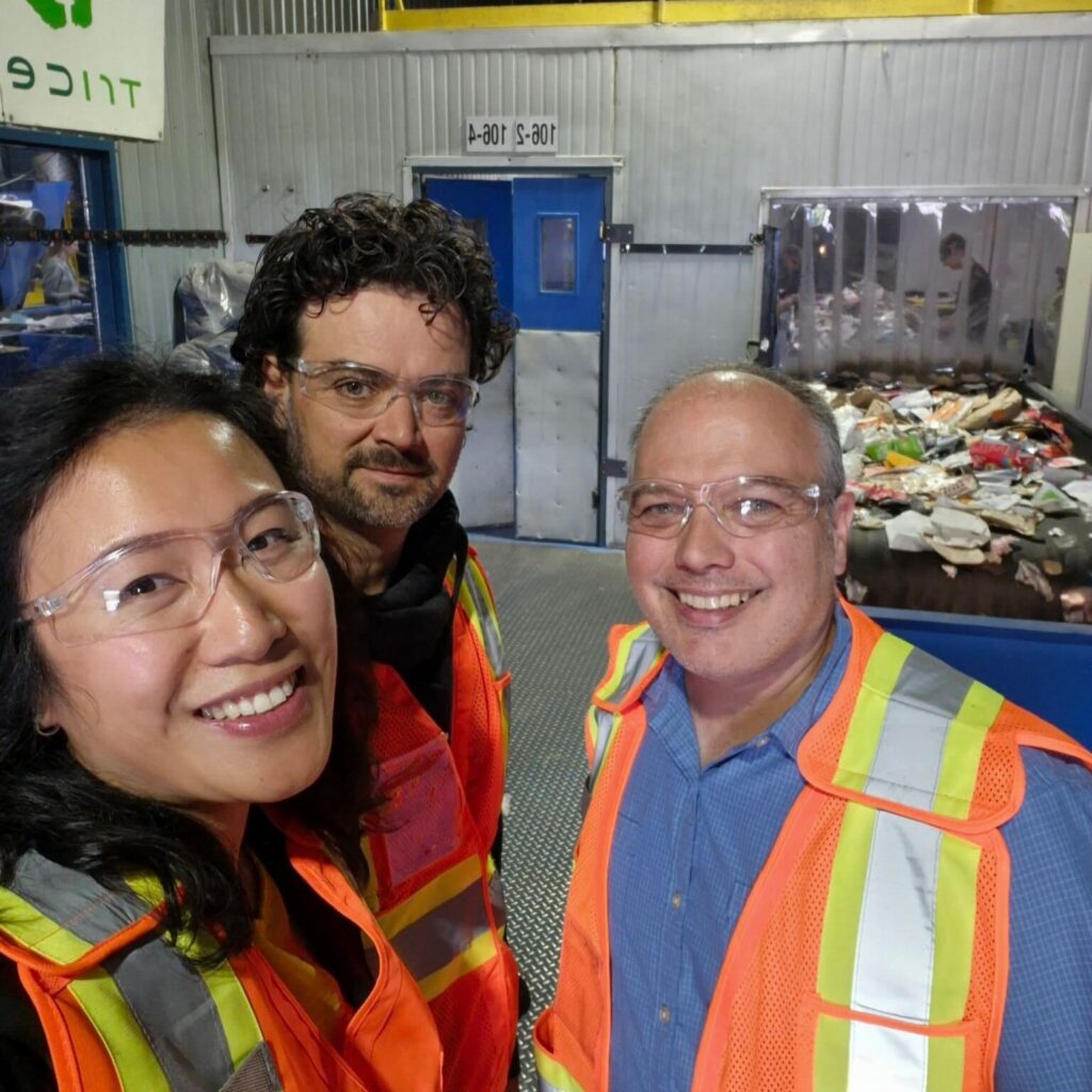 A selfie of Mishel Wong, Shaun Bazinet, and Dany Dumont touring a Tricentris sorting facility.